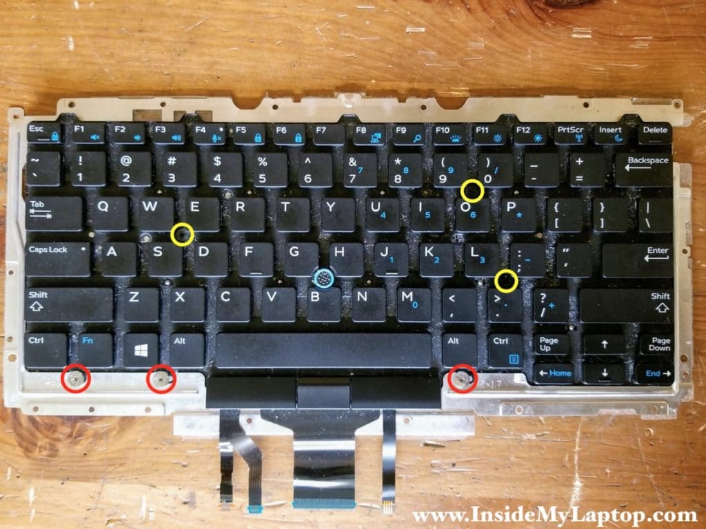 Remove six more screws on the front side of the keyboard.