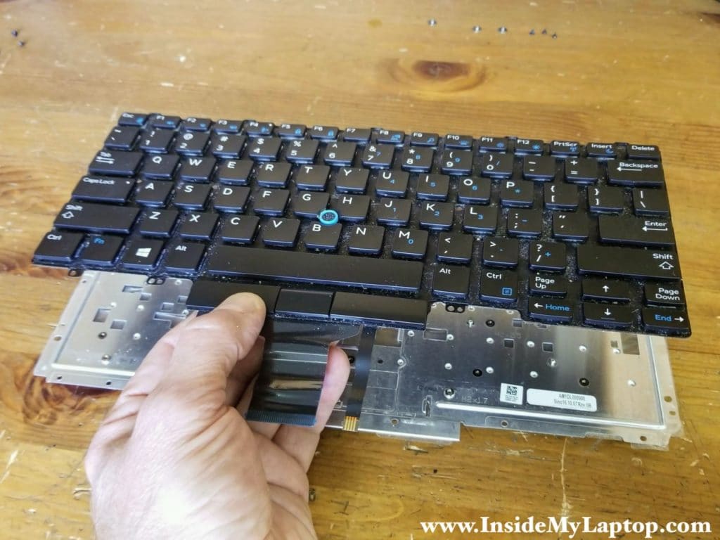 Separate the keyboard from the metal mounting bracket.