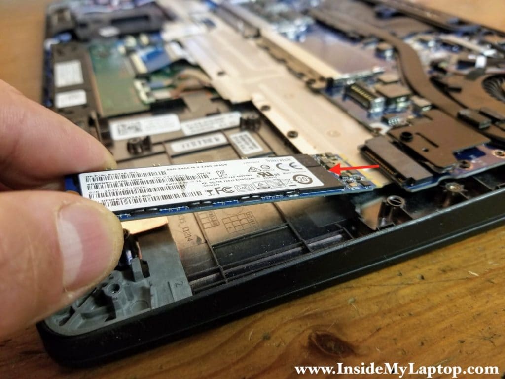 Remove one screw securing the solid state drive and pull it out.