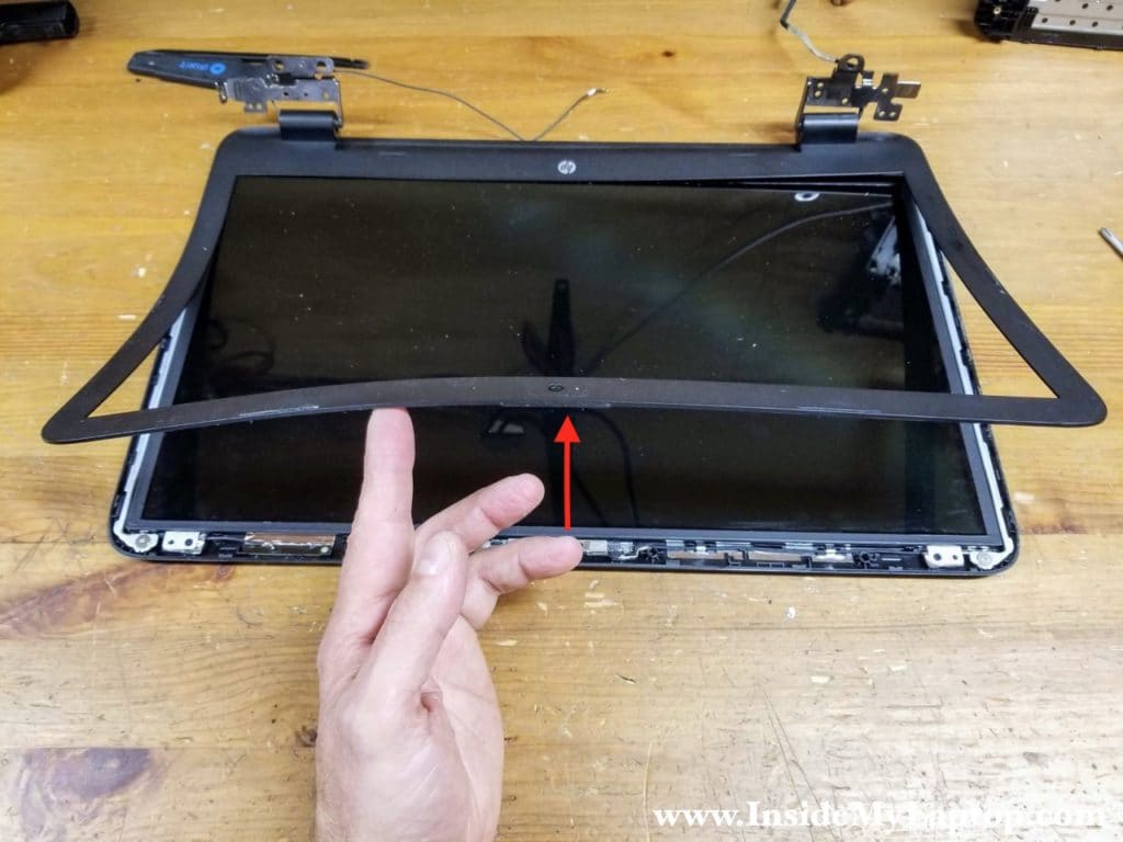 Continue removing the bezel on the top side of the display.