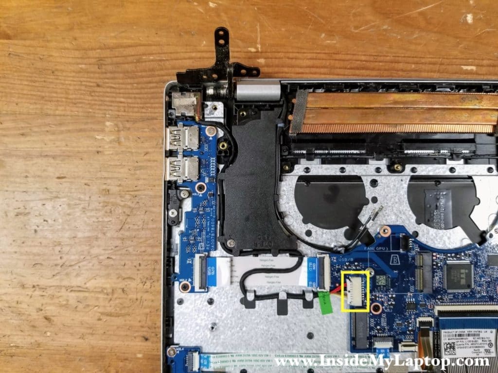 Unplug the DC jack cable from the motherboard. Un-route the cable from the guided path on the top case and the side of the speaker.