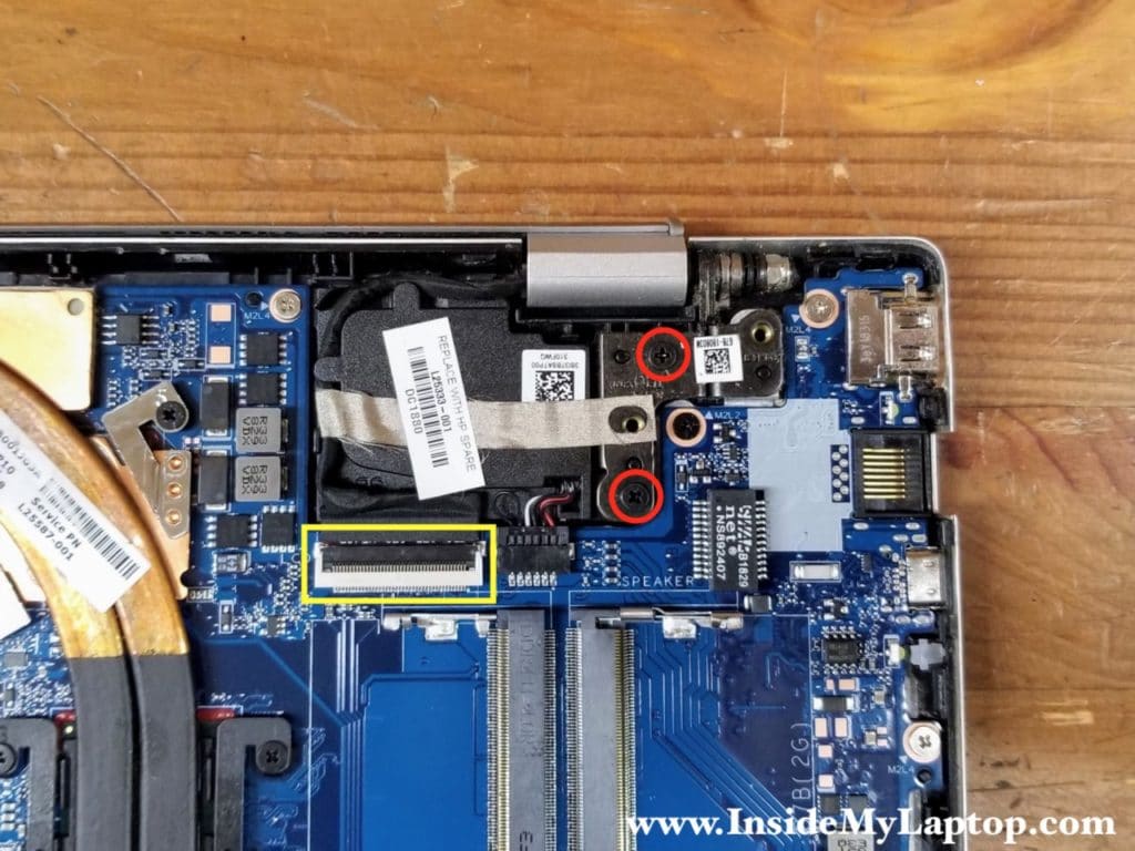 Remove two screws from the left display hinge. Disconnect the display cable from the motherboard.