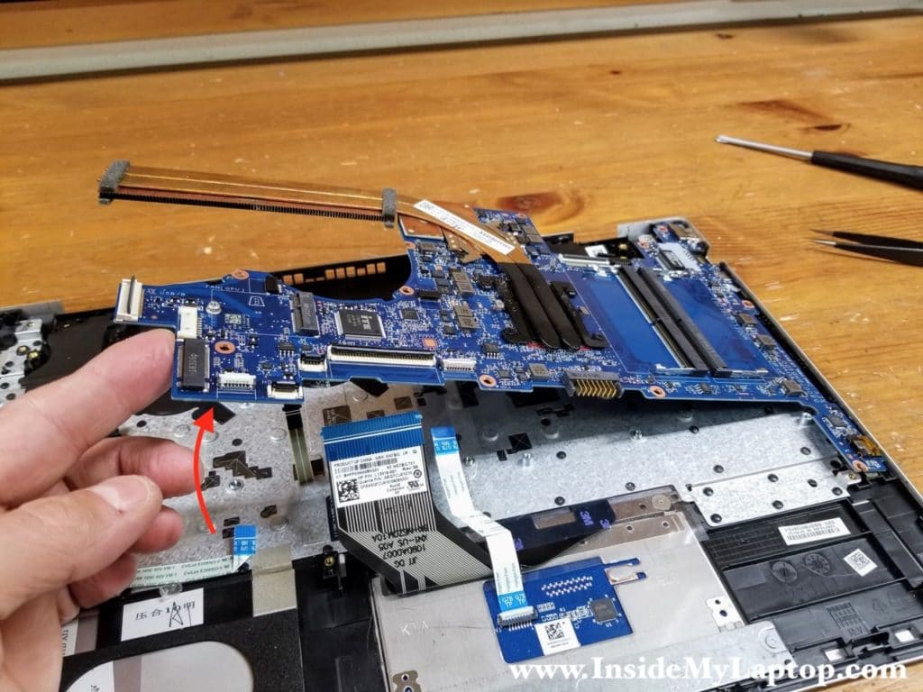 Lift up and remove the motherboard from the top case.