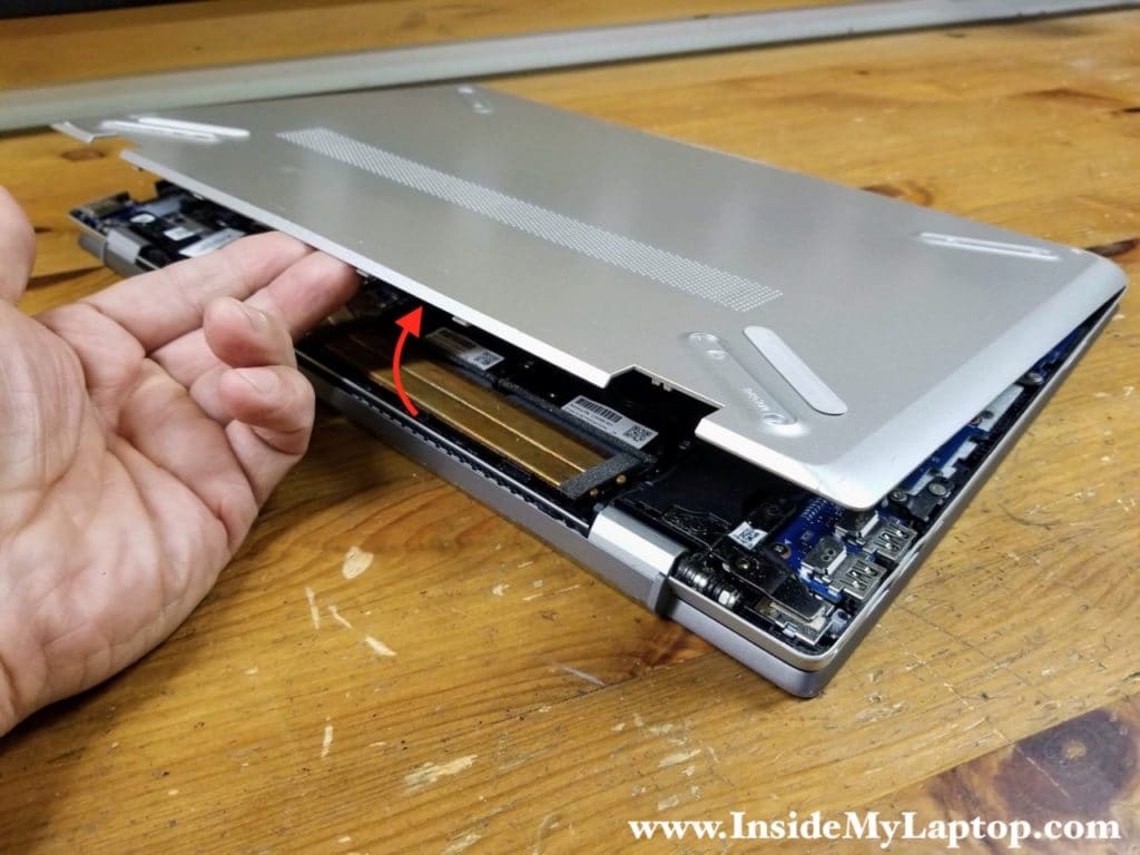 Continue lifting up the base cover with your hands and remove it completely.