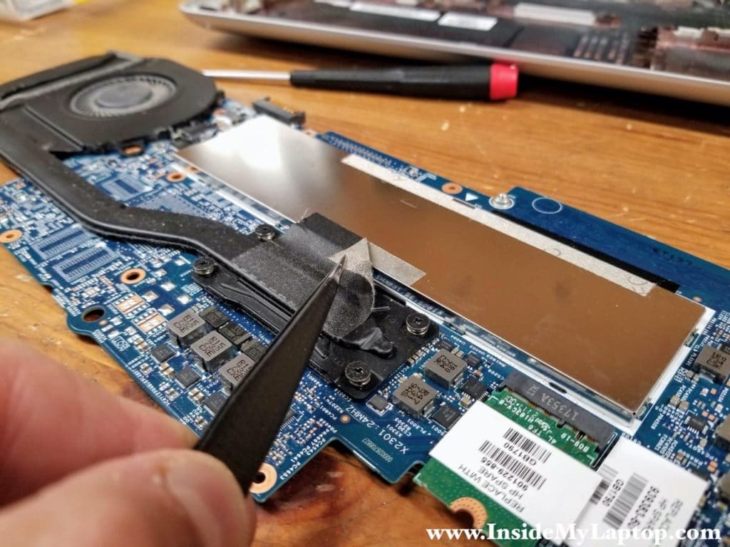 Peel off black tape attached to the memory cover.