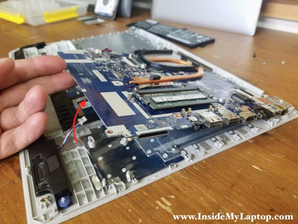 Lift up the motherboard and separate it from the top case.