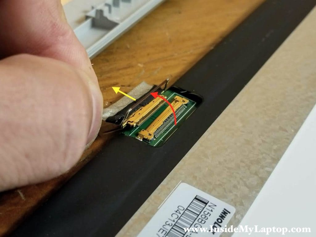 Here's how to disconnect the display cable from the LCD screen.