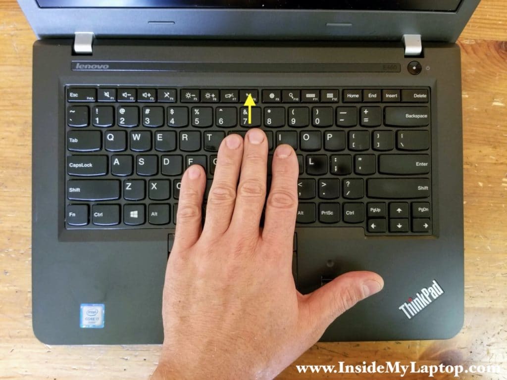 Turn the laptop upside down and slide the keyboard towards the display.