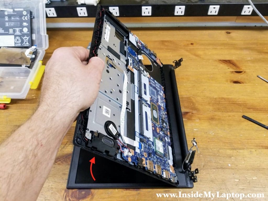 Lift up the top case assembly and slide it from under the display hinges.