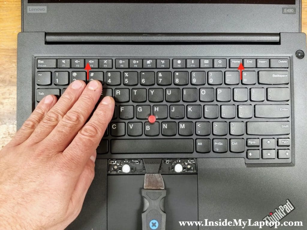 With the case opener located under the frame, slide the keyboard towards the display.