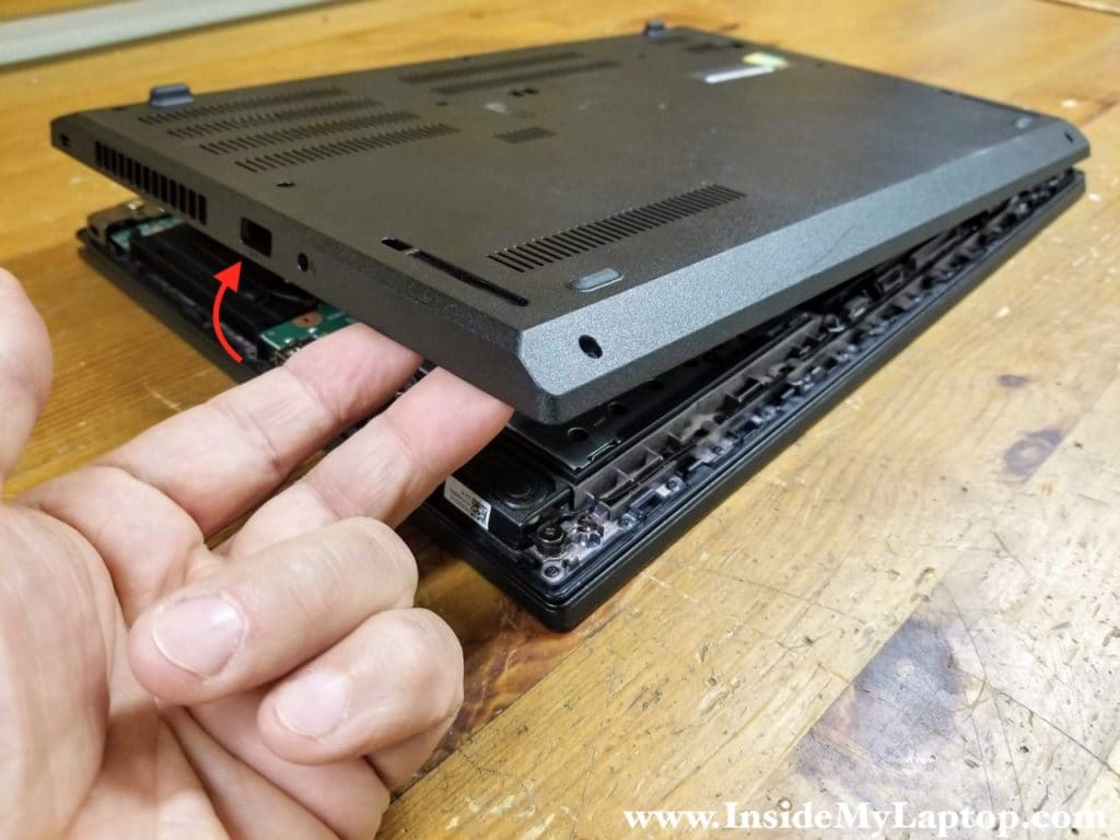 Turn the laptop upside down and continue removing the base cover with your hands.