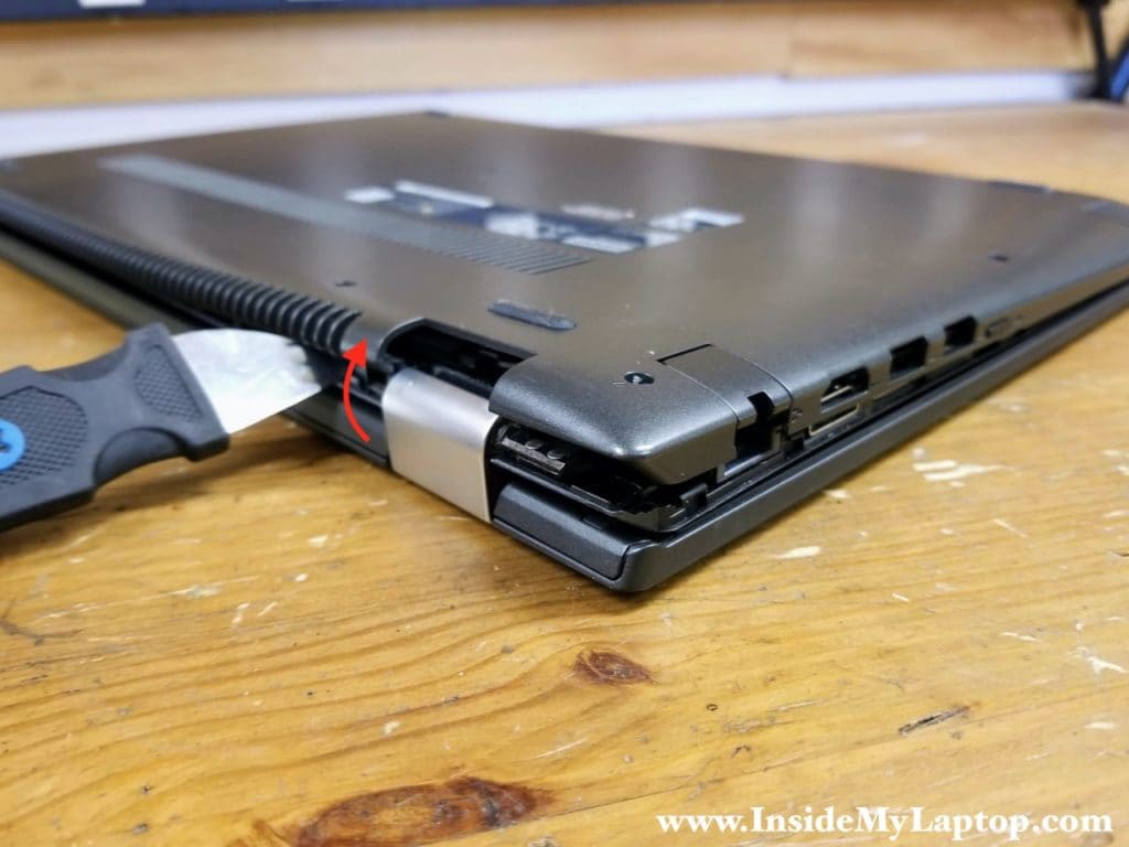 Start separating the base cover from the top case.