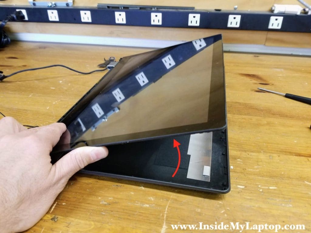 Now you can separate the touchscreen assembly from the display caver and place it upside down on the desk.