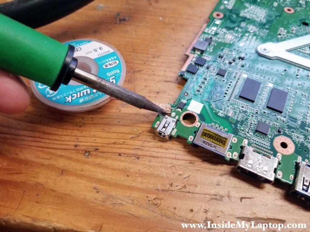 Removing old solder with desoldering wick.