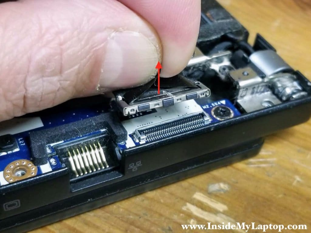 The display cable connector has a black tab on top. Pull the connector up to unplug it from the motherboard.