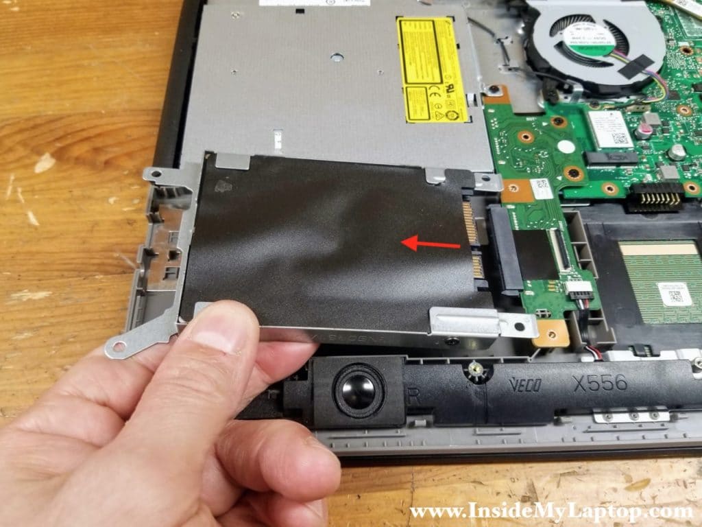 Lift up the left side of the hard drive and pull it away from the motherboard to disconnect from the SATA port.