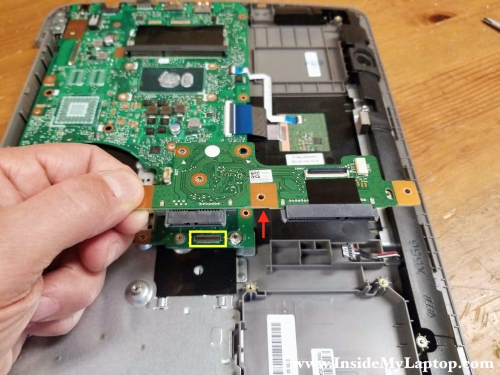 Lift up the optical drive and hard drive connector board to disconnect it from the motherboard and remove it.