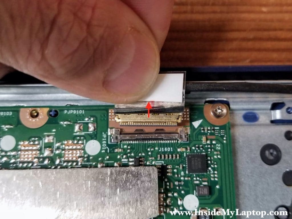 Peel off the clear tape and unplug the display video cable from the motherboard.