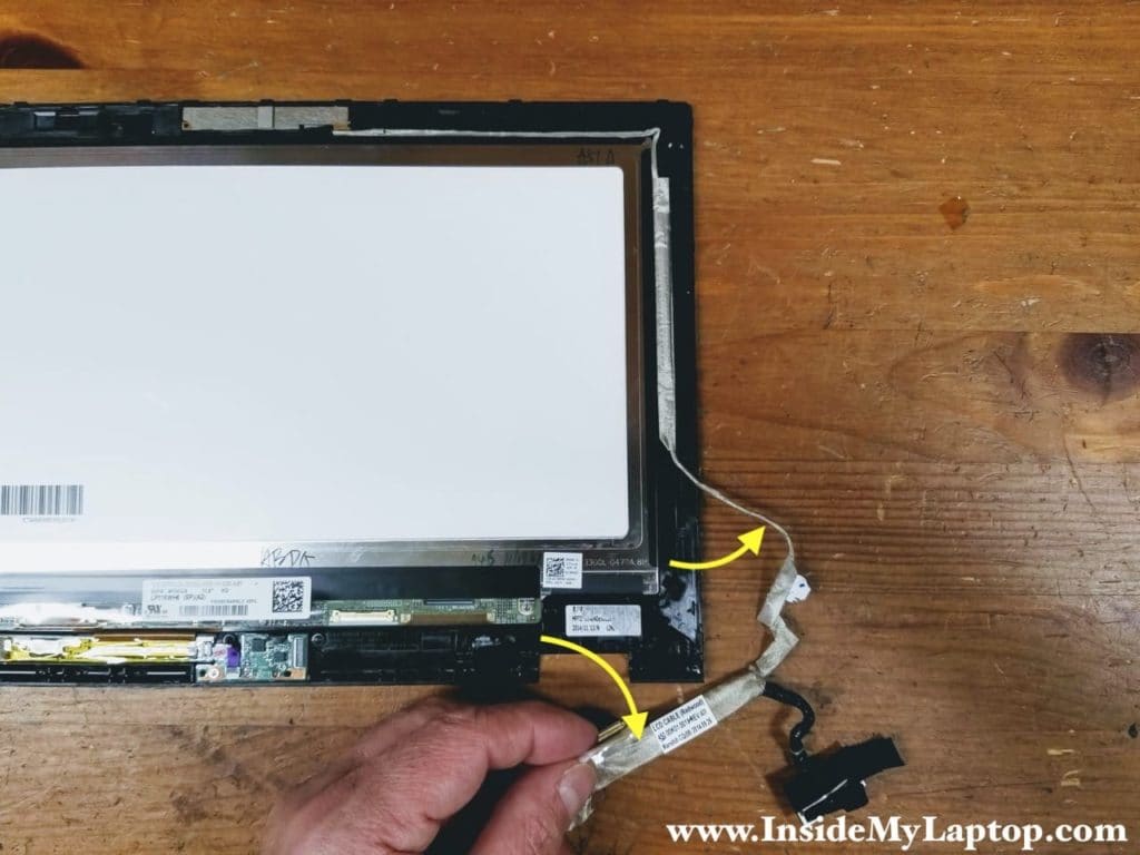 Start separating the display harness from the right side of the bezel.