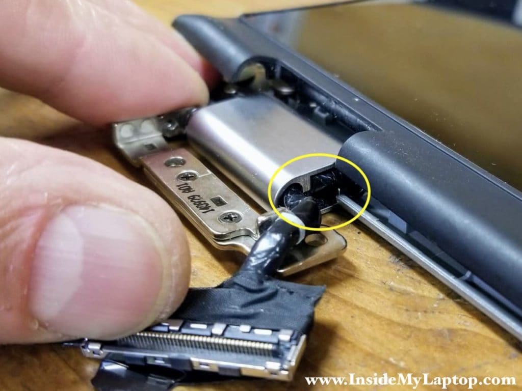 The display cable is routed inside the left hinge cover.