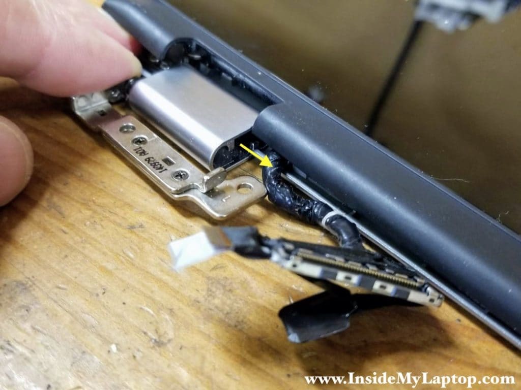 Carefully pull the display cable out of the left hinge cover.