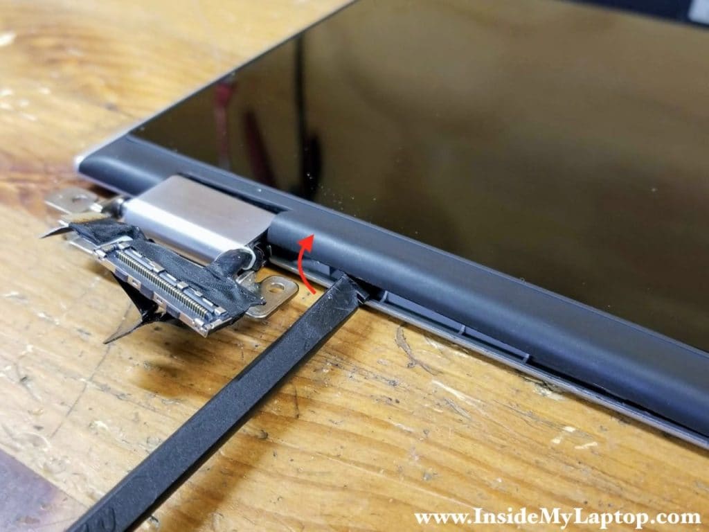 Start separating the touchscreen assembly from the display back cover on the bottom part of the display panel.