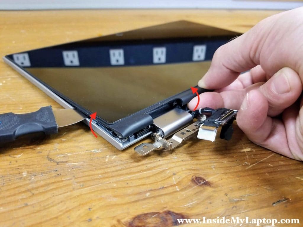 Continue removing the touchscreen assembly around the hinge area.