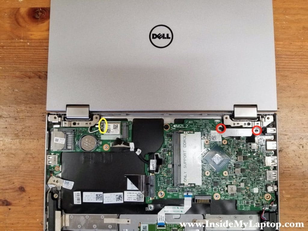 Remove two screws from the metal bracket covering the display/webcam connectors. Lift up and remove the bracket.