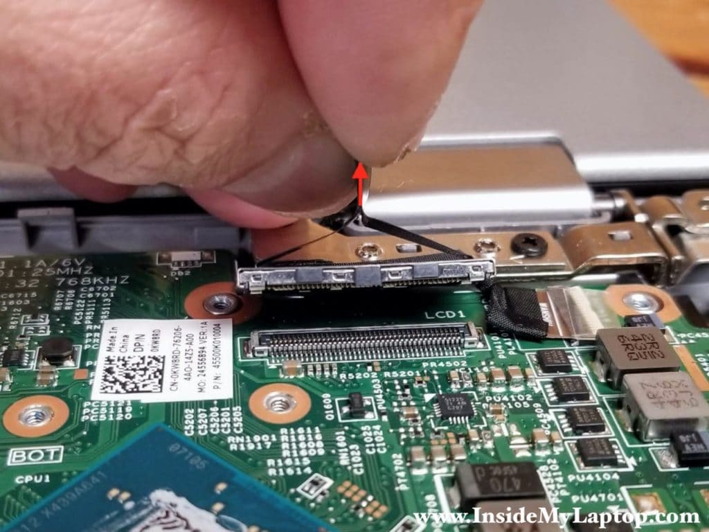 Pull the display cable connector up to disconnect it from the motherboard.