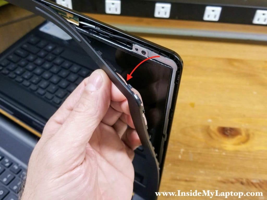Continue removing the screen bezel with your hands.