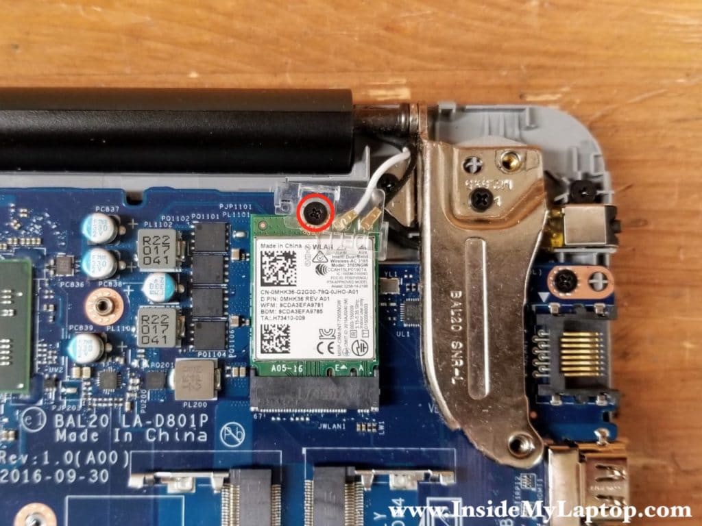 Remove one screw securing the clear cover over the Wi-Fi antenna cables. Remove the clear cover.