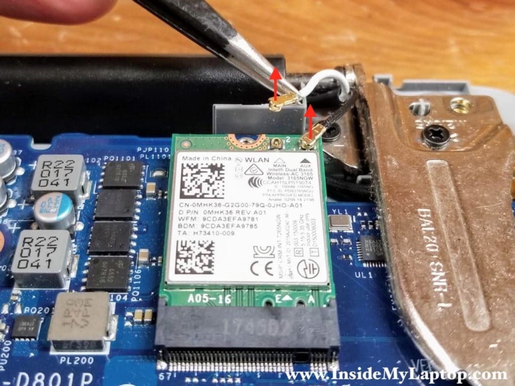 Lift up both antenna cables "heads" to un-snap them from the wireless card.