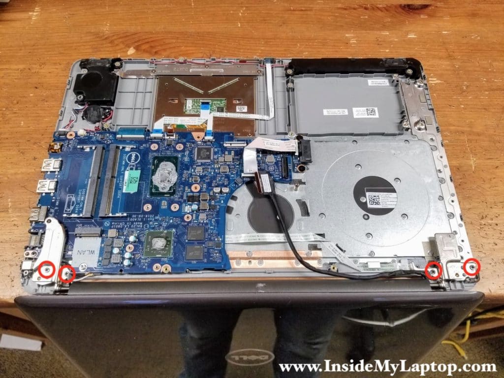 Remove four screws securing the left and right display hinges.