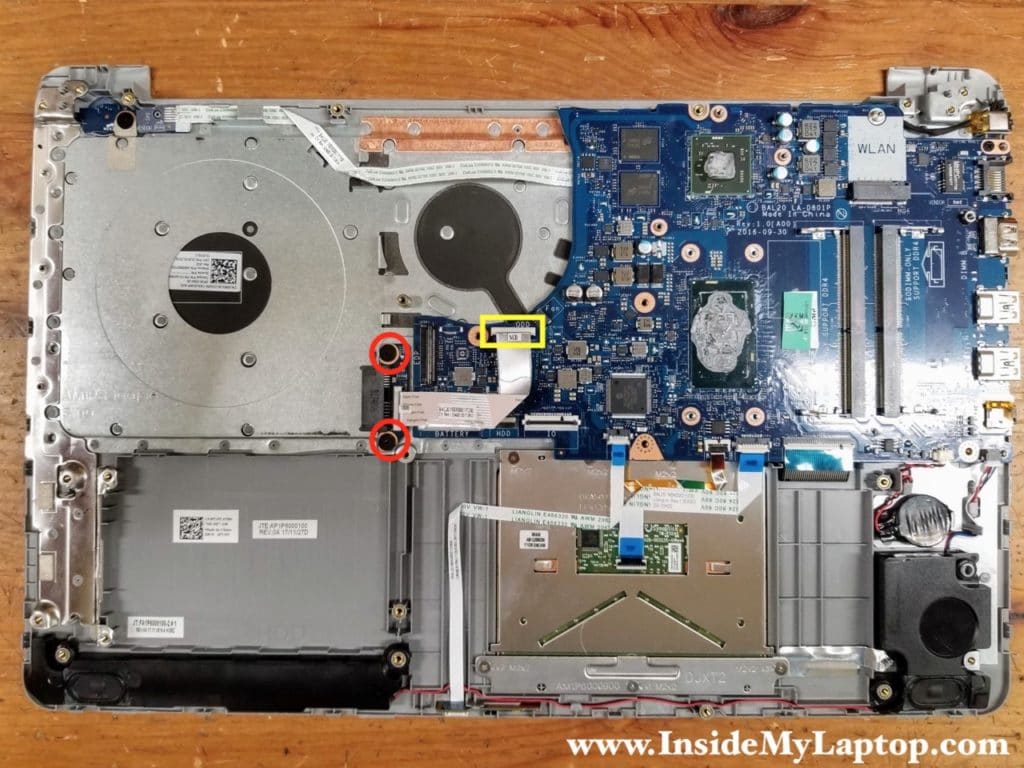 Remove two screws from the optical drive connector board. Disconnect the cable from the motherboard.