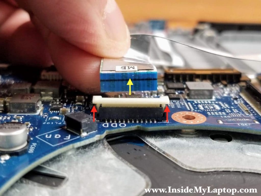 Here's how to release the optical drive connector board cable.