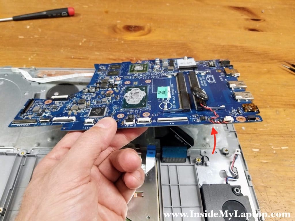 Lift up the motherboard to separate it from the top case and turn upside down.