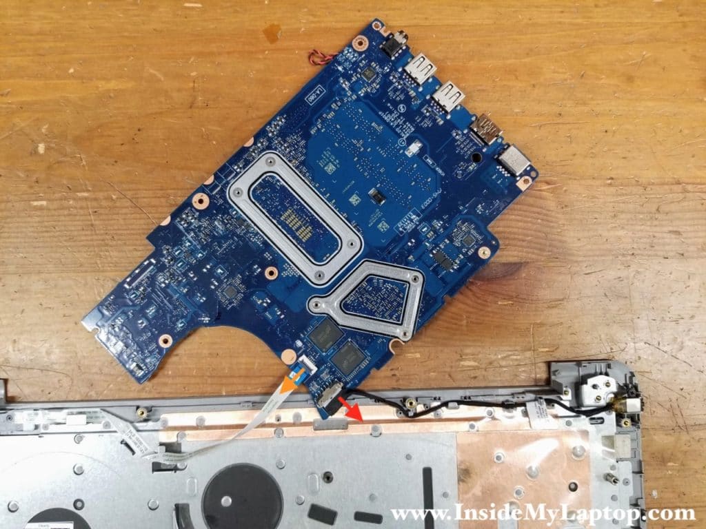 Disconnect the power button cable (orange arrow) and the DC power jack cable (red arrow).