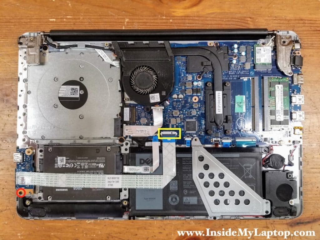 Remove one screw securing the I/O board (USB and card reader board). Disconnect the I/O cable from the motherboard.