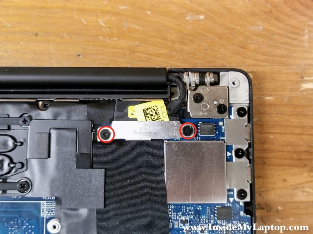 Remove two screws from the display cable cover. Lift up and remove the cover.