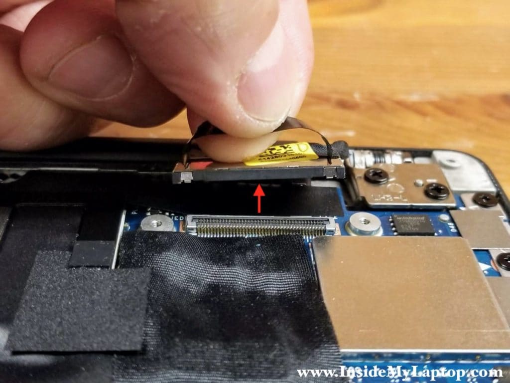 Disconnect the display cable from the motherboard. Lift up the connector by the black tab on top.