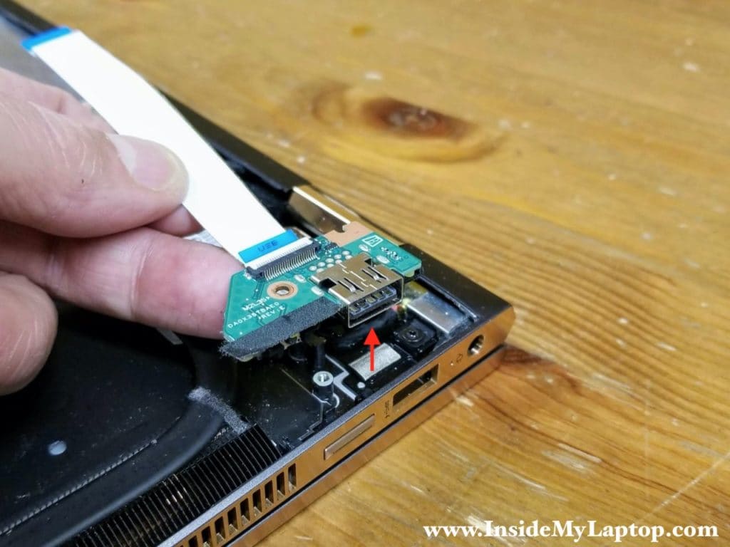 Lift up and remove the USB power button board with the I/O cable attached.