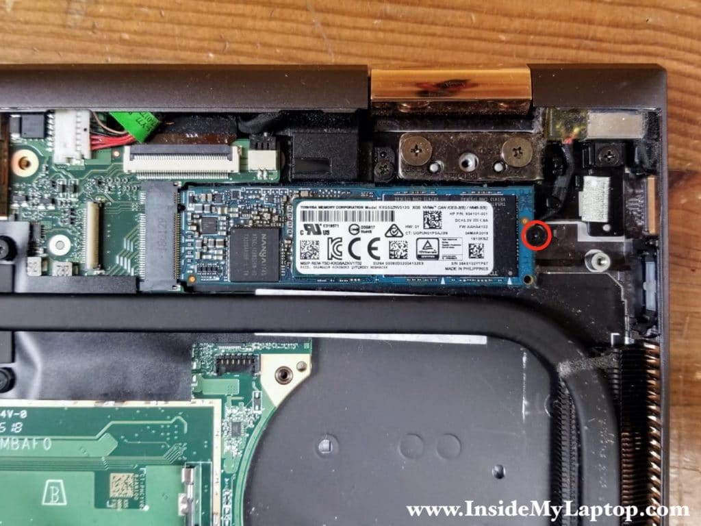 Remove one screw securing the PCIe NVMe M.2 solid state drive.