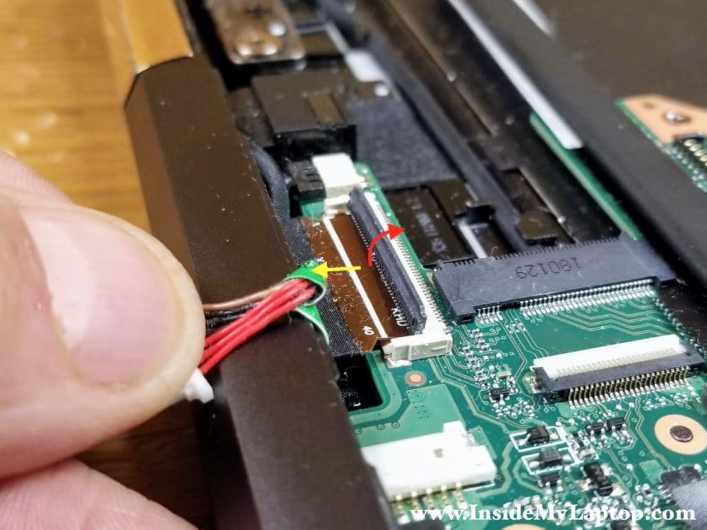 Unlock the connector and remove the display panel cable.