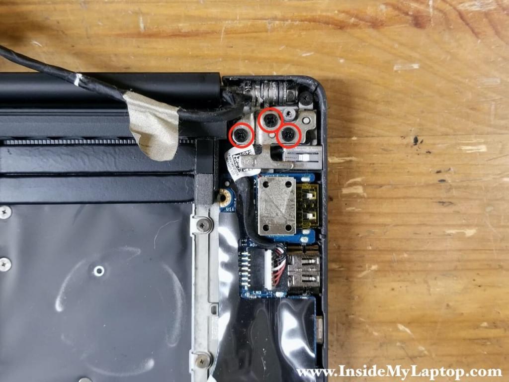 Remove three screws securing the left display hinge.