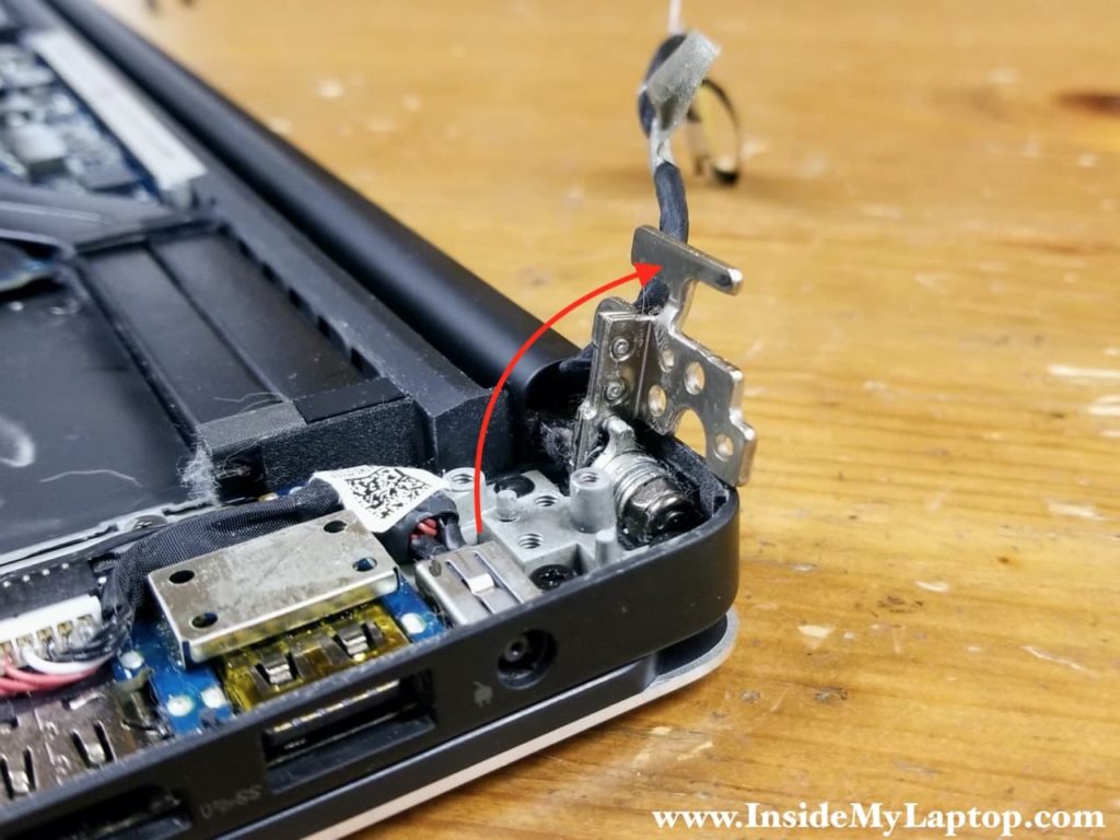 Lift up the display hinge as it shown on the picture.