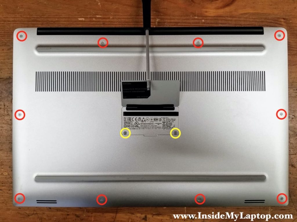 Remove ten Torx T5 screws and two Phillips screws securing the base cover.