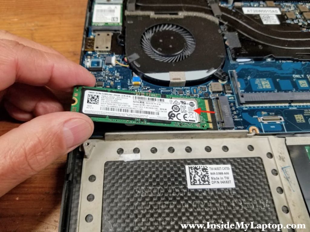 Remove one screw securing the SSD and remove it from the slot.