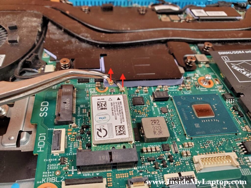 Carefully disconnect two antenna cables from the wireless card.