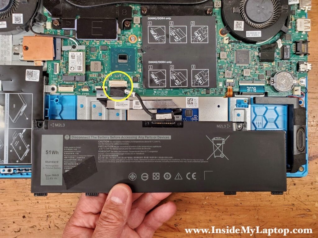 Lift up the battery to access the cable connector.