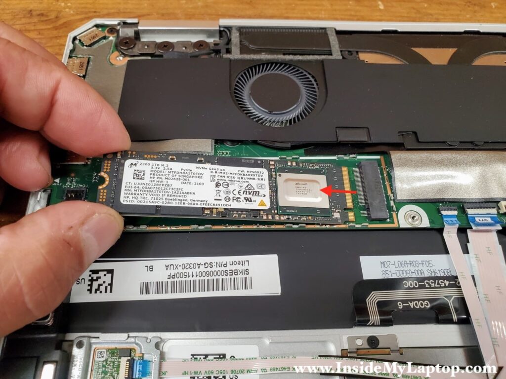 Pull SSD out of the slot to remove it.